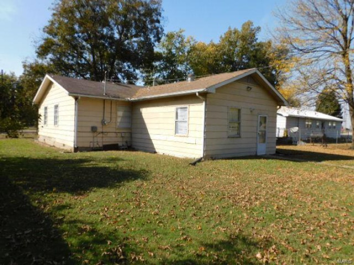 View of side of property with a yard