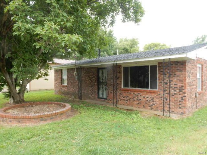 Back of property featuring a lawn
