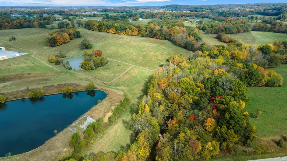 Drone / aerial view with a water view and a rural view