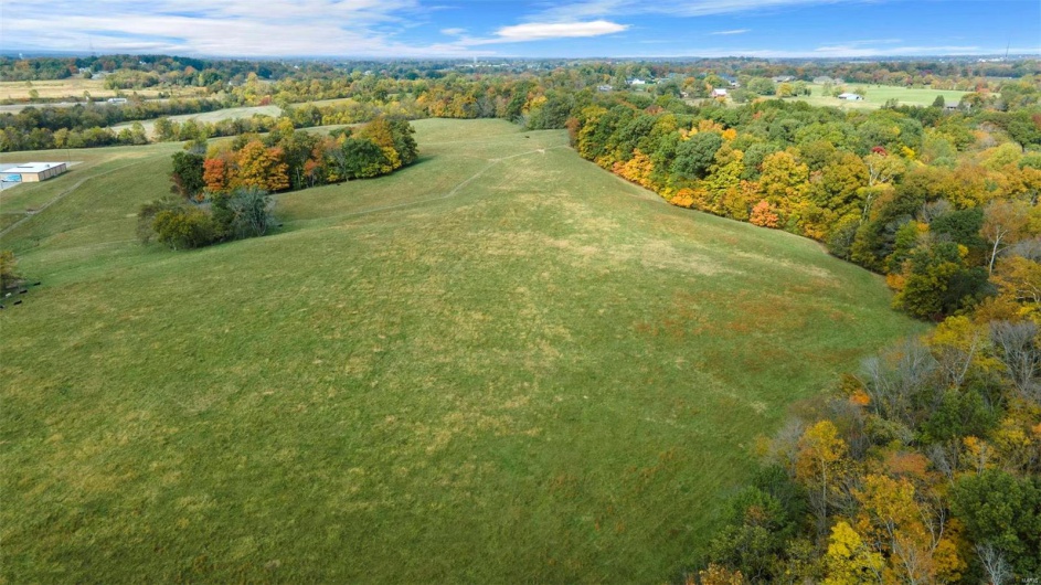 Birds eye view of property with a rural view