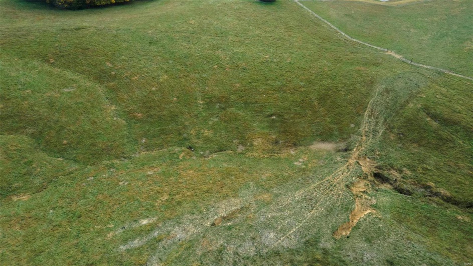 Birds eye view of property featuring a rural view