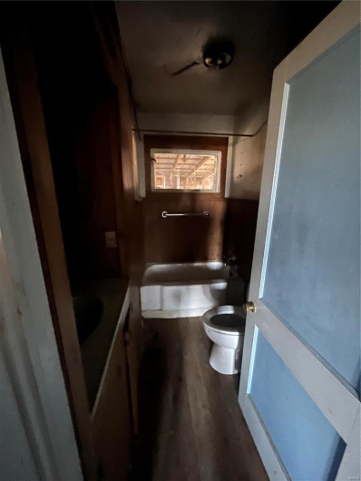 Bathroom with toilet, vanity, and hardwood / wood-style floors