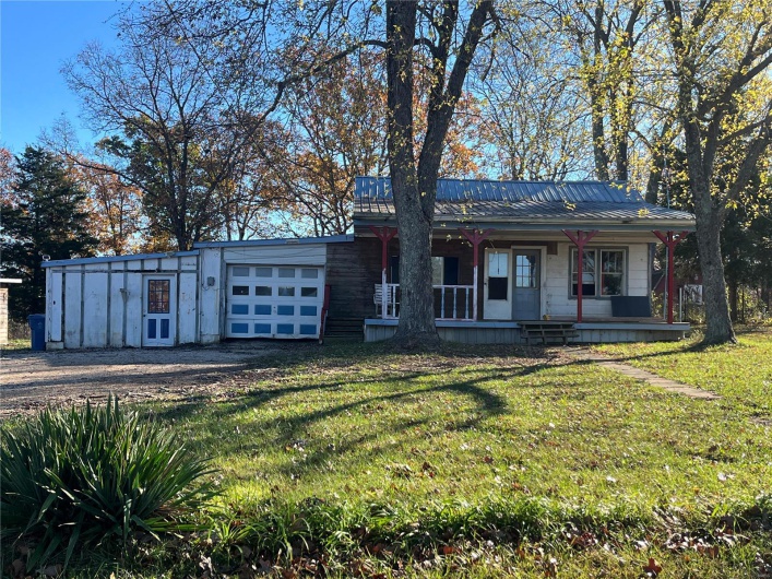 View of front of home with a front lawn and covered porch