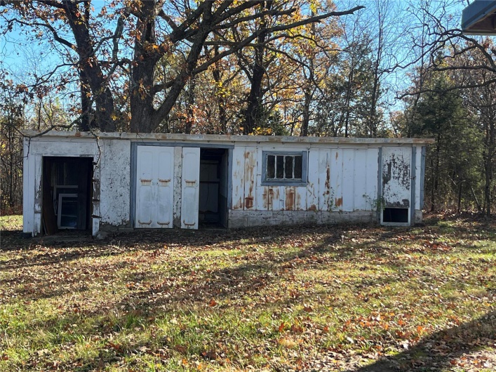 View of outbuilding with a yard