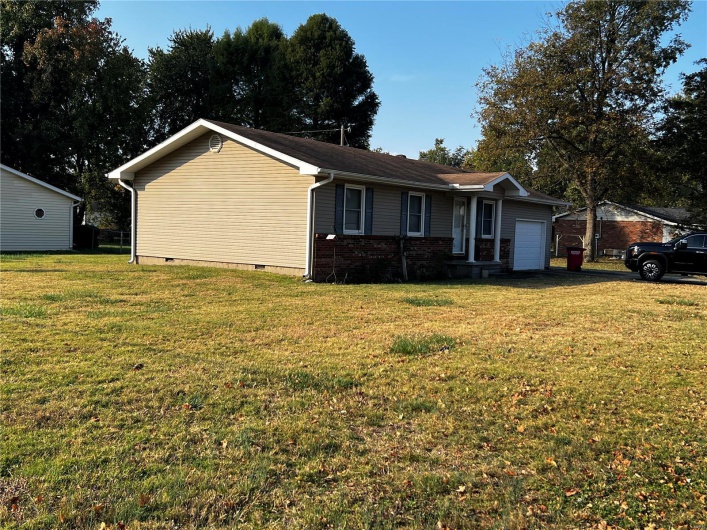 Ranch-style home with a garage and a front yard