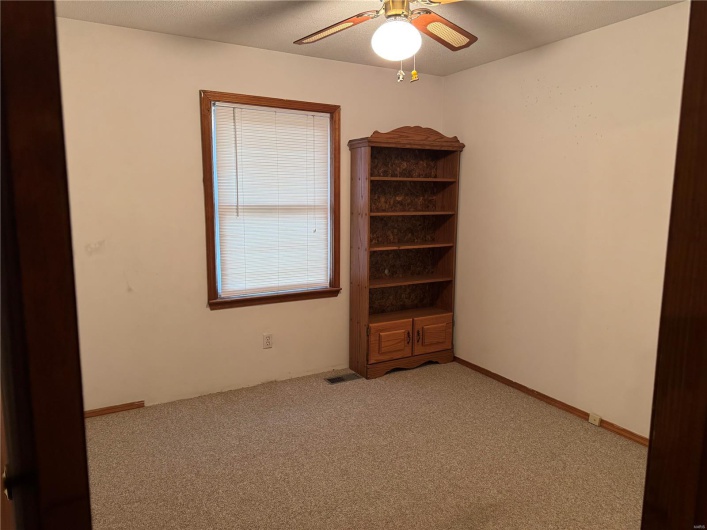 Spare room featuring ceiling fan and light carpet