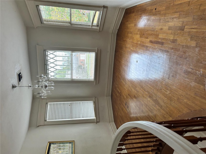 Unfurnished dining area featuring baseboards, visible vents, a chandelier, and hardwood / wood-style flooring