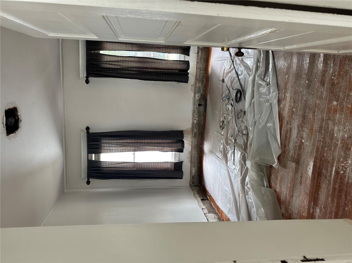 Empty room with hardwood / wood-style flooring