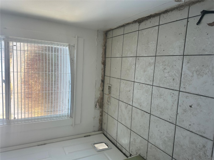 Unfurnished room with a wealth of natural light and light tile patterned floors