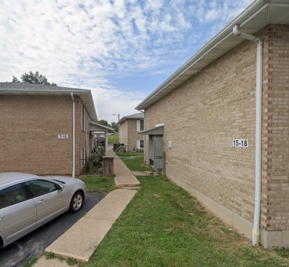 View of side of home with a yard
