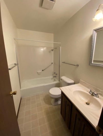 Full bathroom with shower / tub combination, vanity, and toilet