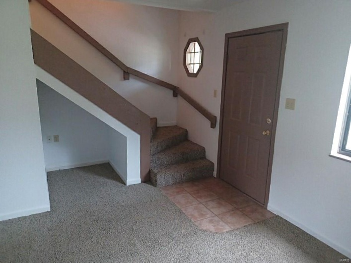 Foyer entrance with light carpet