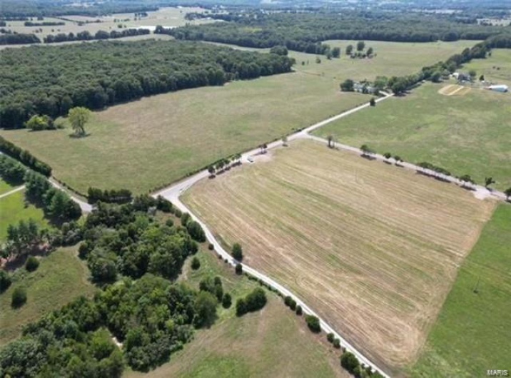 Birds eye view of property with a rural view