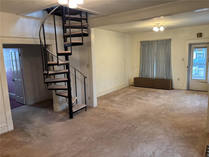 from dining area toward living room and bedrooms staircase to 2nd floor 