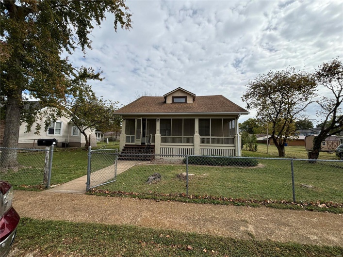 1.5 story style house featuring a front yard and a front screened porch , Sidewalks a large oversized detached garage. Large Open 2nd floor with tons of opportunity 