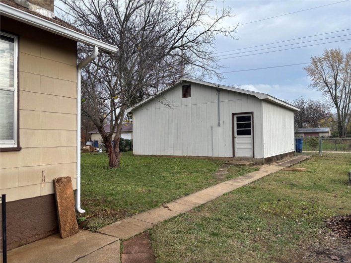 View of outbuilding featuring a yard