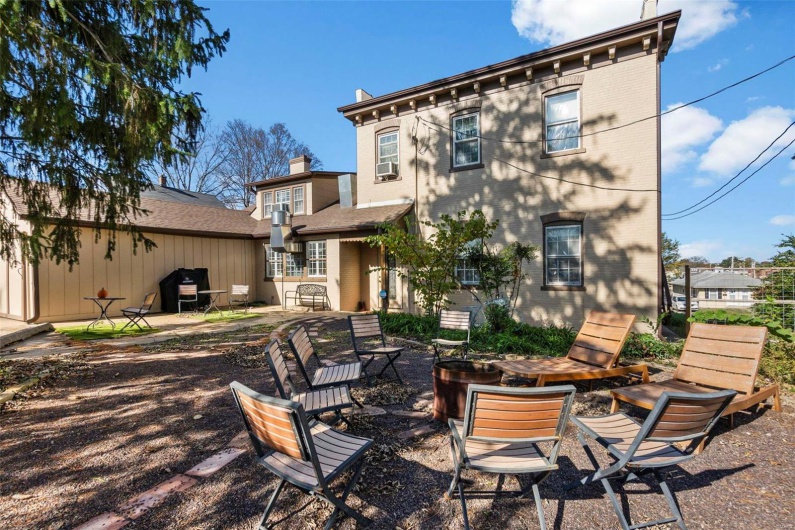 Back of property with a fire pit and a patio area