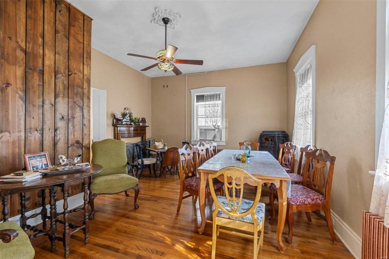 Dining area featuring hardwood / wood-style floors, ceiling fan, and vaulted ceiling