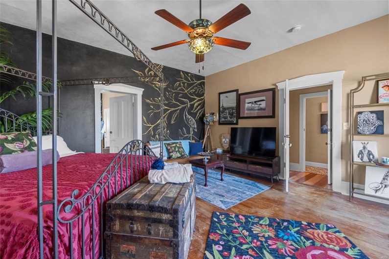 Bedroom with hardwood / wood-style floors and ceiling fan