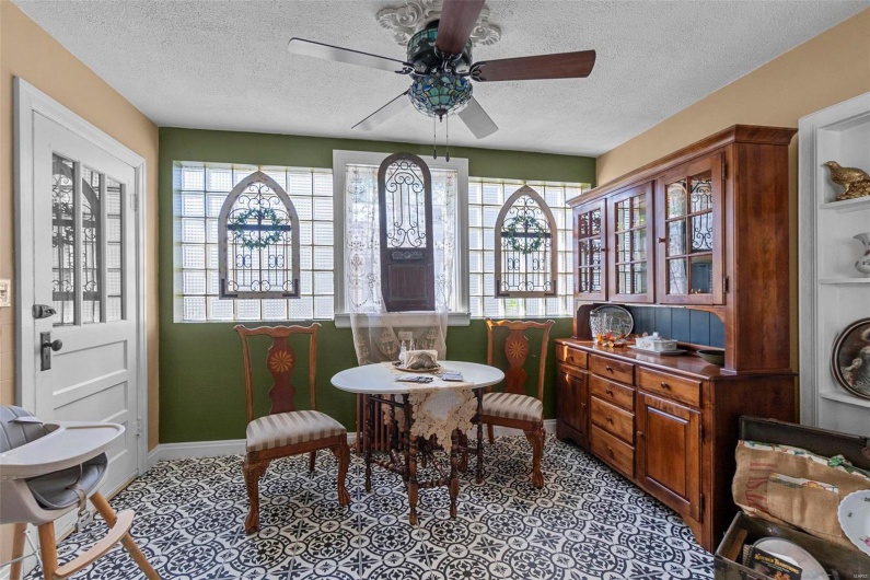 Dining area featuring a wealth of natural light, a textured ceiling, and ceiling fan