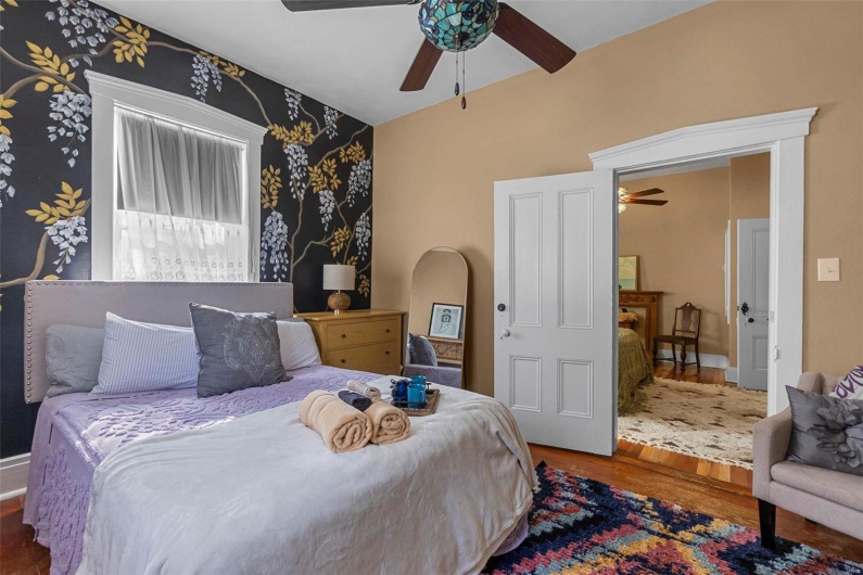 Bedroom with hardwood / wood-style flooring and ceiling fan
