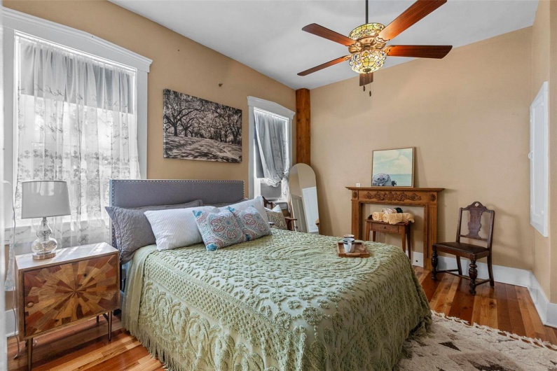 Bedroom with hardwood / wood-style flooring and ceiling fan