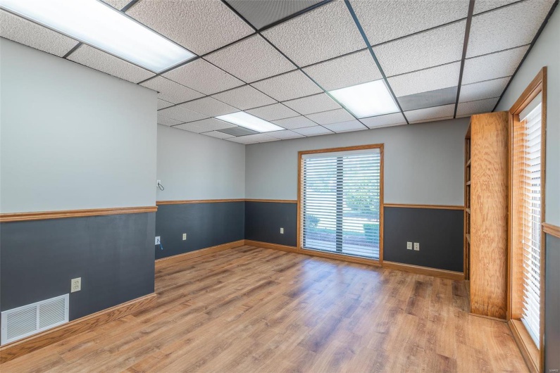 Empty room featuring a drop ceiling and hardwood / wood-style flooring