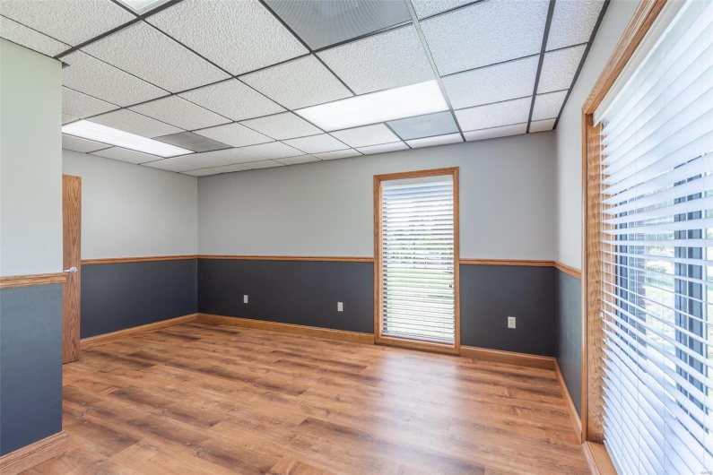 Unfurnished room with hardwood / wood-style floors and a paneled ceiling