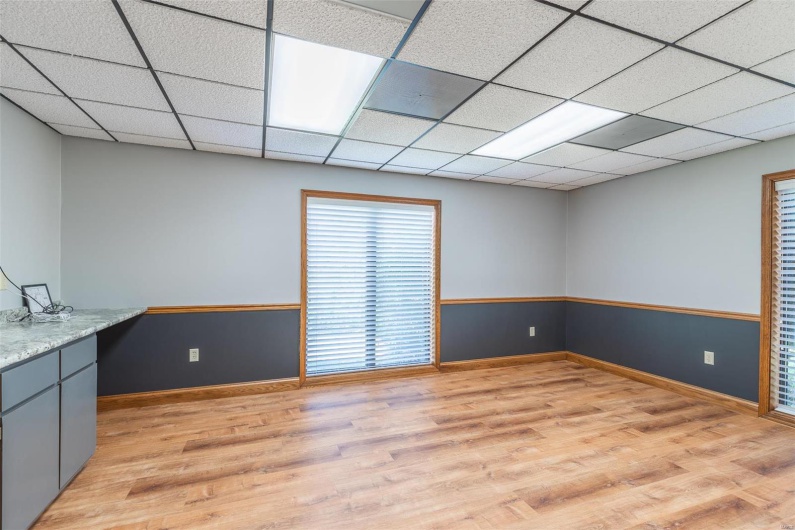 Interior space with a drop ceiling and light hardwood / wood-style floors