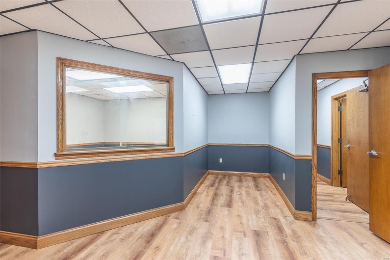 Spare room featuring a paneled ceiling and light hardwood / wood-style flooring