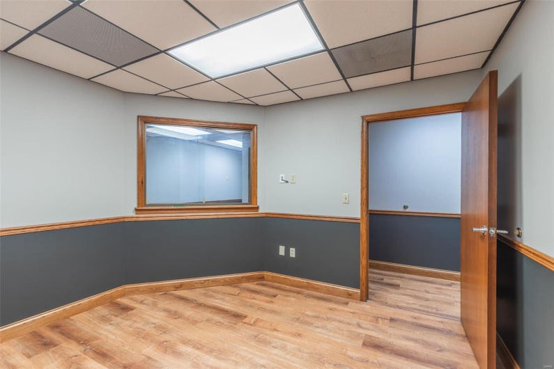 Spare room with light hardwood / wood-style flooring and a drop ceiling