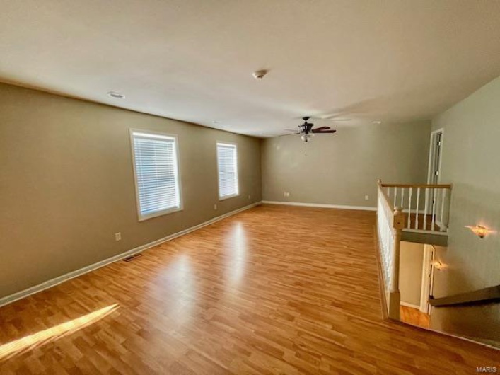Spare room featuring ceiling fan and light wood-type flooring