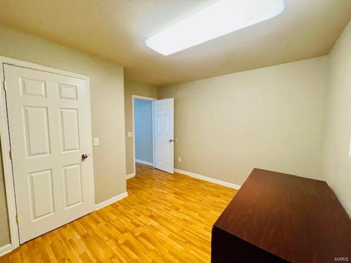 Empty room featuring wood-type flooring