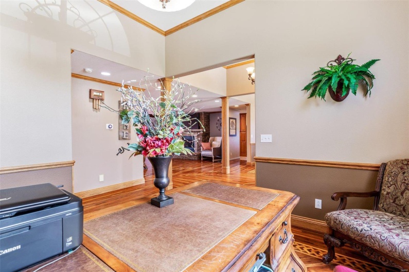 Interior space featuring hardwood / wood-style flooring and ornamental molding