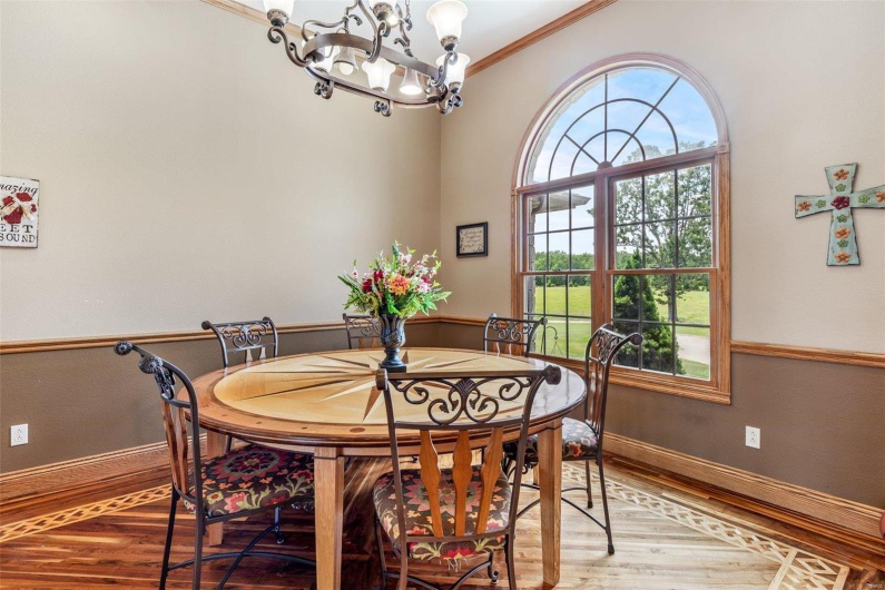 Dining area featuring a chandelier, hardwood / wood-style floors, and crown molding