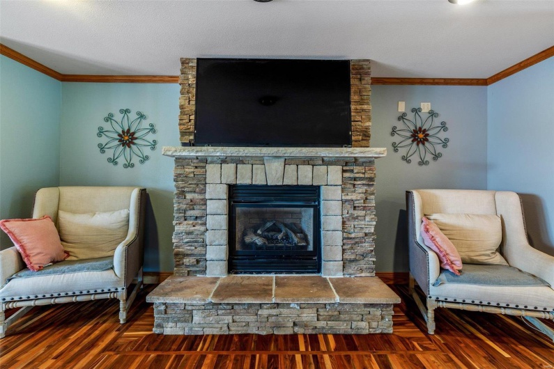 Living room featuring a fireplace, dark hardwood / wood-style floors, and ornamental molding