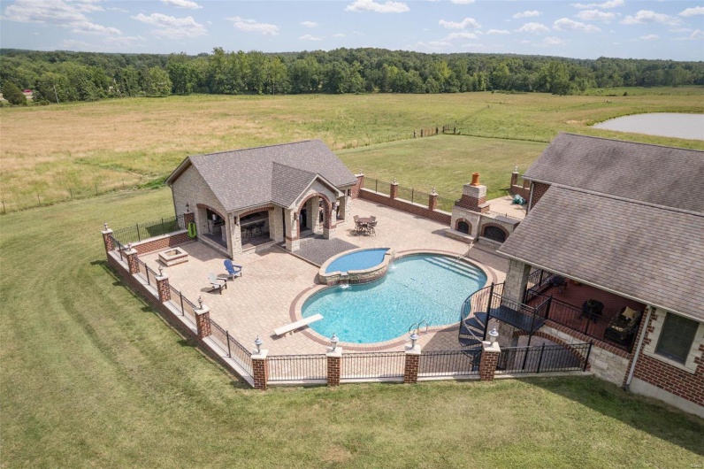 View of pool with a diving board and a patio