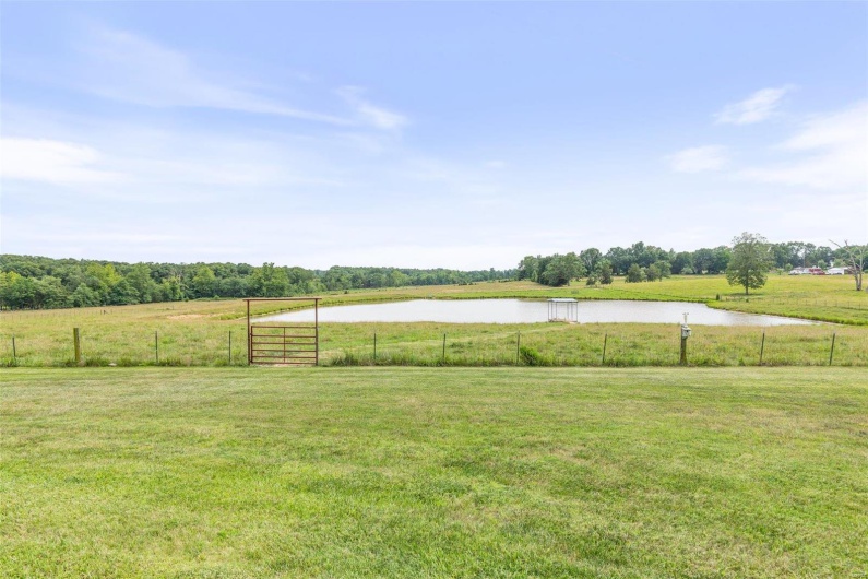 View of yard with a rural view and a water view