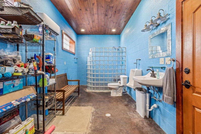 Bathroom featuring concrete floors and toilet