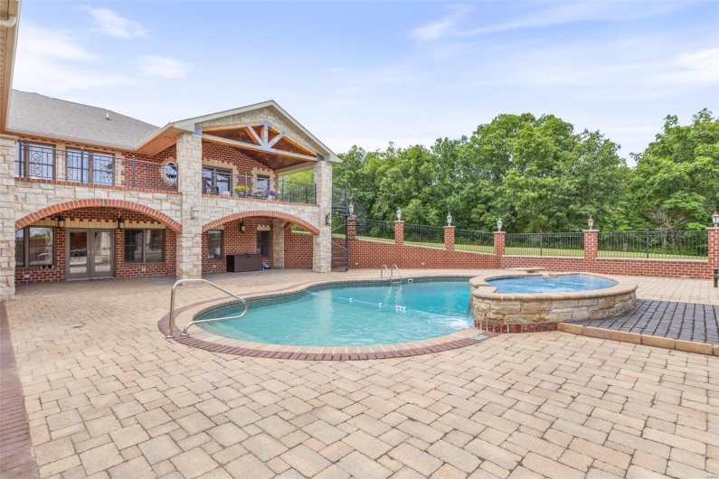 View of pool featuring a patio area and an in ground hot tub