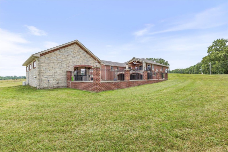 Back of house with a lawn