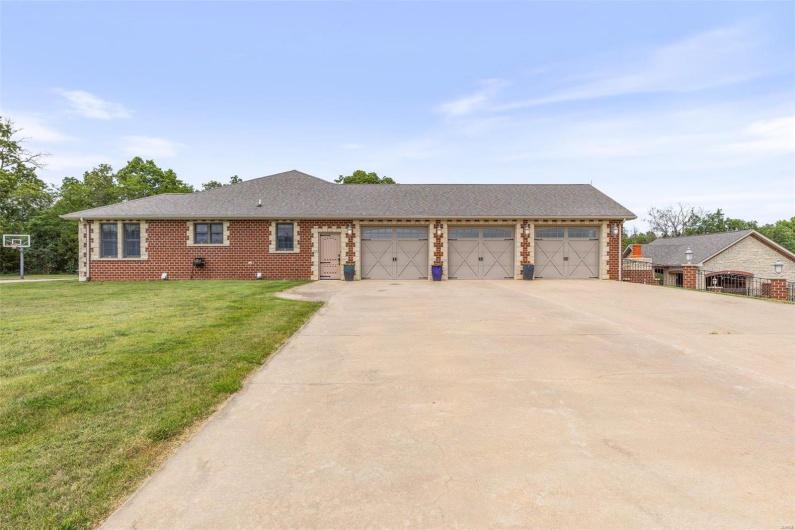 Ranch-style house featuring a front yard and a garage