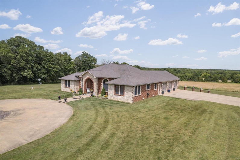 Ranch-style house featuring a front lawn