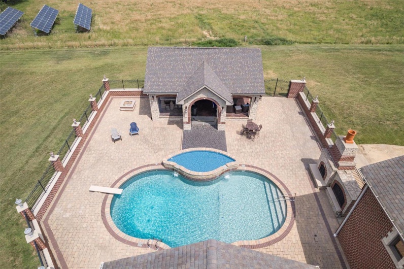 View of pool with a diving board and a patio area