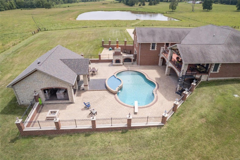 View of swimming pool with a fireplace, a patio, and a water view