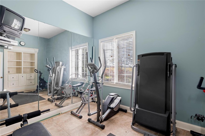 Workout room with tile patterned flooring