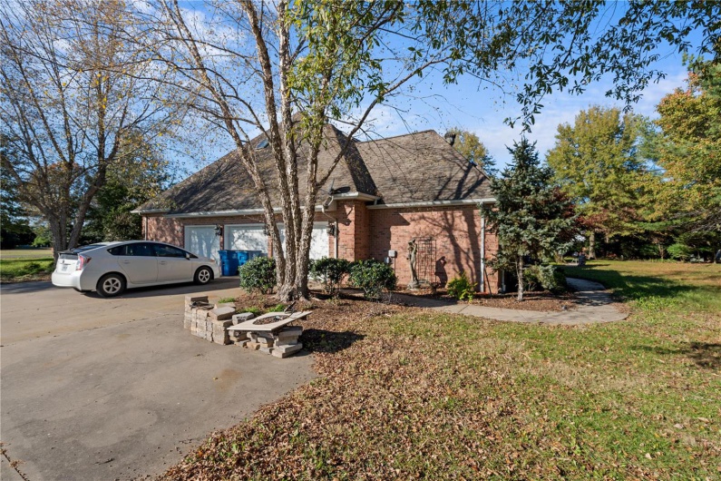 View of front of home featuring a front yard and a garage