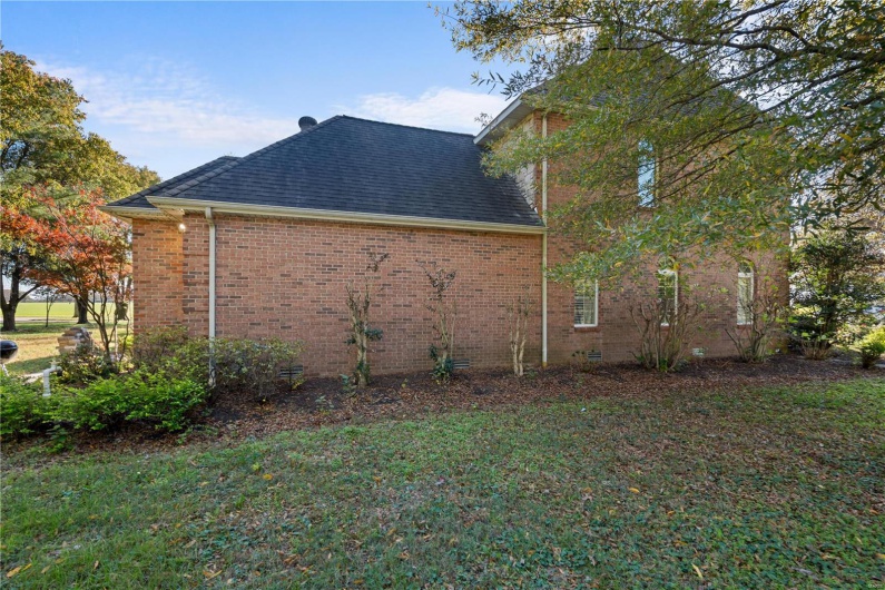 View of property exterior with a lawn
