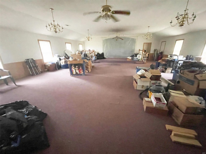 Misc room with carpet, ceiling fan, and lofted ceiling