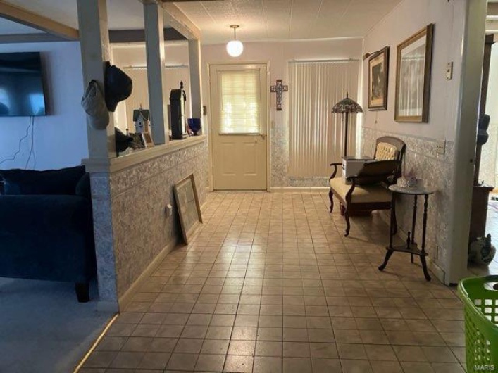 Foyer entrance with tile patterned flooring